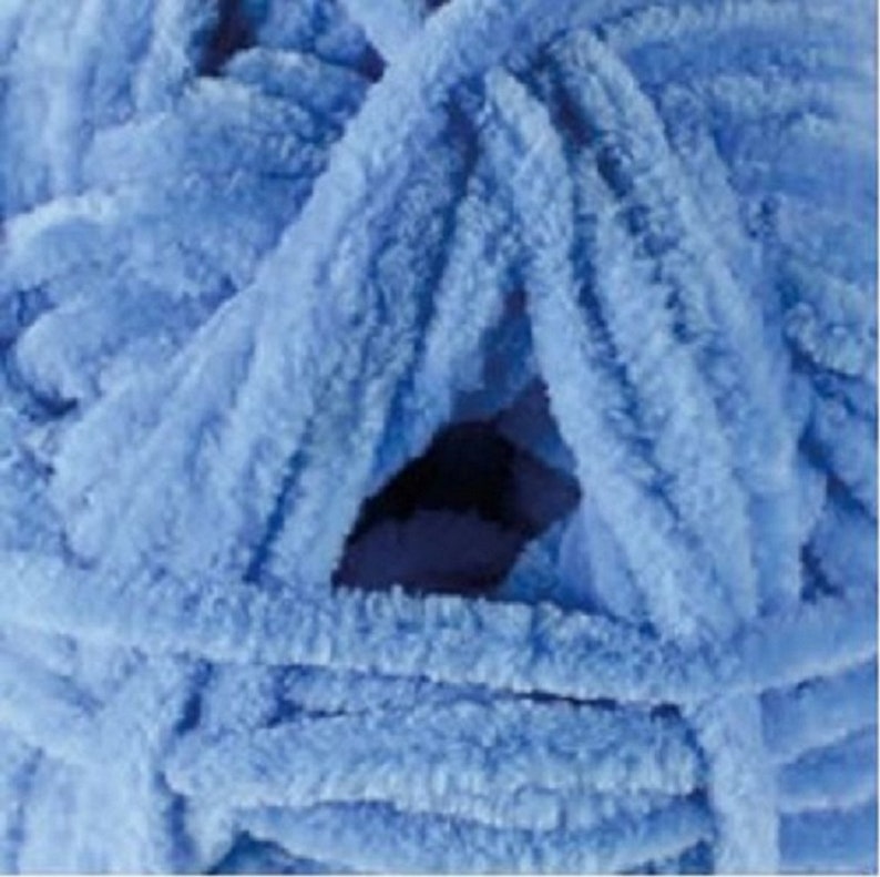 May include: A skein of light blue fuzzy yarn. The yarn is soft and fluffy, and it is perfect for making blankets, scarves, and other cosy items.