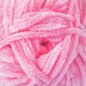 May include: A close-up of a ball of pink yarn. The yarn is soft and fluffy, and it is ideal for knitting or crocheting.
