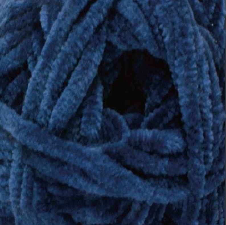 May include: A skein of deep blue yarn with a fuzzy texture. The yarn is made of soft, chenille fibres.