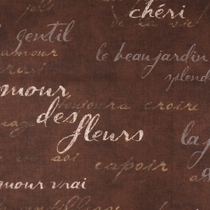 May include: A brown fabric background with white and gold text. The text includes the words "l'amour vrai", "amour des fleurs", "la joie de la", "le beau jardin", "cher", and "gentil".