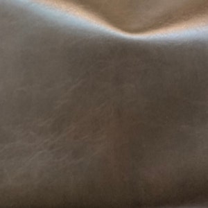 May include: Close-up of a textured, brown leather surface.