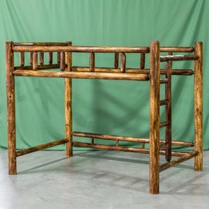 May include: A loft bed frame constructed from dark brown stained logs with a visible wood grain texture. The structure features a safety railing around the top tier, a vertical ladder attached to the side, and four sturdy corner posts.
