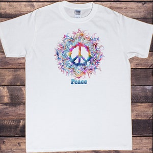May include: White t-shirt with a colorful peace sign graphic and the word "Peace" printed below it.