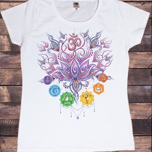 May include: White t-shirt with a colorful mandala design featuring a lotus flower, Om symbol, and seven chakras. The chakras are represented by circles with Sanskrit symbols and are arranged in a vertical line.