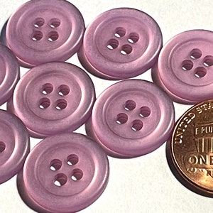 May include: Eight purple plastic buttons with four holes each. The buttons are approximately the size of a US penny.
