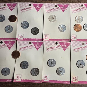 May include: Ten cards with a white background and pink borders. Each card features the text "FASHIONABLE" and "Le Chic Buttons" in black. The cards display various silver and white buttons with a 25 cent price tag.