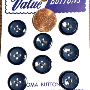 May include: A card of navy blue buttons with four holes, a penny for scale, and the words "Value BUTTONS" in blue script. The card also has the text "TACOMA, WASHINGTON" and "WASHABLE".