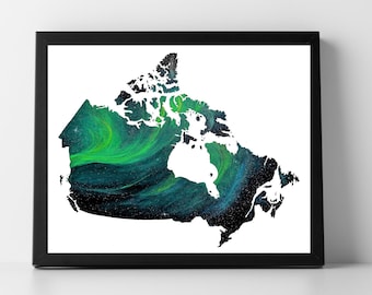 May include: A black framed print of a white outline of Canada with a green and blue aurora borealis inside.