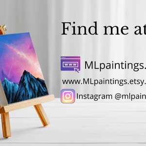 May include: A small painting on a wooden easel depicts a mountain range with a pink and purple sky. The painting is titled "Find me at: MLpaintings.org, www.MLpaintings.etsy.com, Instagram @mlpaintings".