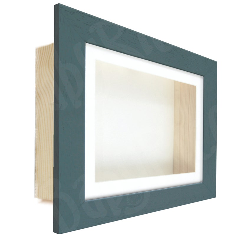 May include: A teal blue shadow box frame with a white mat and a wood backing. The frame is made of wood and has a distressed finish.
