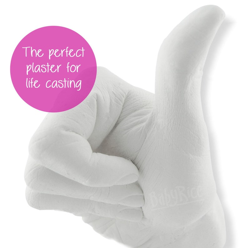 May include: White plaster hand cast in a thumbs up pose. The perfect plaster for life casting.