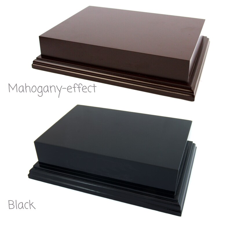 May include: Two rectangular display plinths, one mahogany-effect and one black. Both have a stepped base.