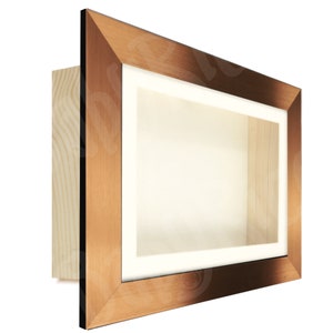 May include: A copper-coloured picture frame with a white mount and a wooden backing. The frame is designed to display a three-dimensional object, such as a medal or a small sculpture.
