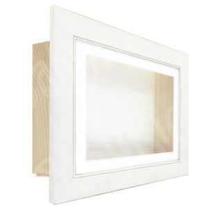 May include: White shadow box frame with a white mount and a clear glass front. The frame is made of wood and has a natural wood back.