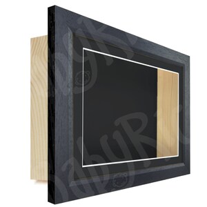 May include: A dark gray wood picture frame with a white mat and a wood backing. The frame is designed to display a three-dimensional object.