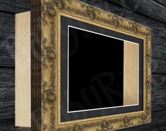May include: A gold ornate frame with a black mat and a wood insert. The frame is on a dark wood background.