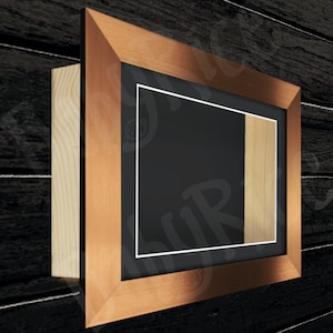 May include: A copper-coloured picture frame with a black mount and a wood backing. The frame has a white inner border.