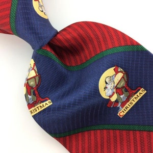 May include: A blue and red striped silk tie with a green stripe. The tie features a repeated pattern of a cartoon Santa Claus holding a globe with the word "Christmas" written on it.