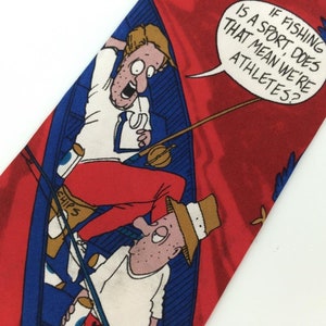 May include: A red silk tie with a cartoon illustration of two men fishing in a boat. The text on the tie reads "If fishing is a sport does that mean we're athletes?"