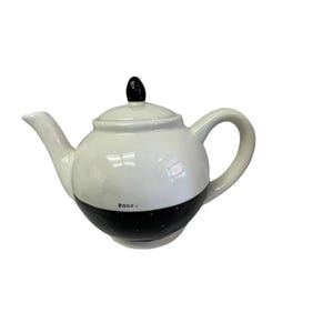 May include: White and black ceramic teapot with a rounded body, a curved spout, and a loop handle. The lid has a black knob. The bottom half of the teapot is black with white polka dots. The word "Pour." is printed on the front.