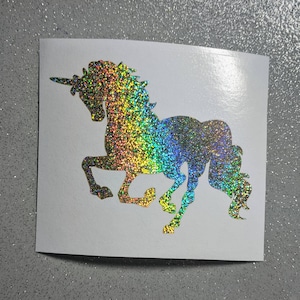 May include: A rainbow glitter unicorn silhouette decal. The unicorn is facing right and has a flowing mane and tail.