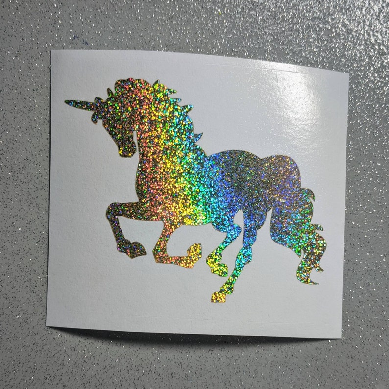 May include: A rainbow glitter unicorn silhouette decal. The unicorn is facing right and has a flowing mane and tail.