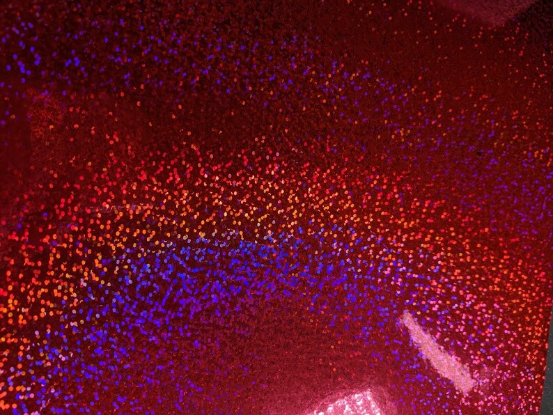 May include: Red iridescent fabric with a gradient of orange, blue, and purple glitter.