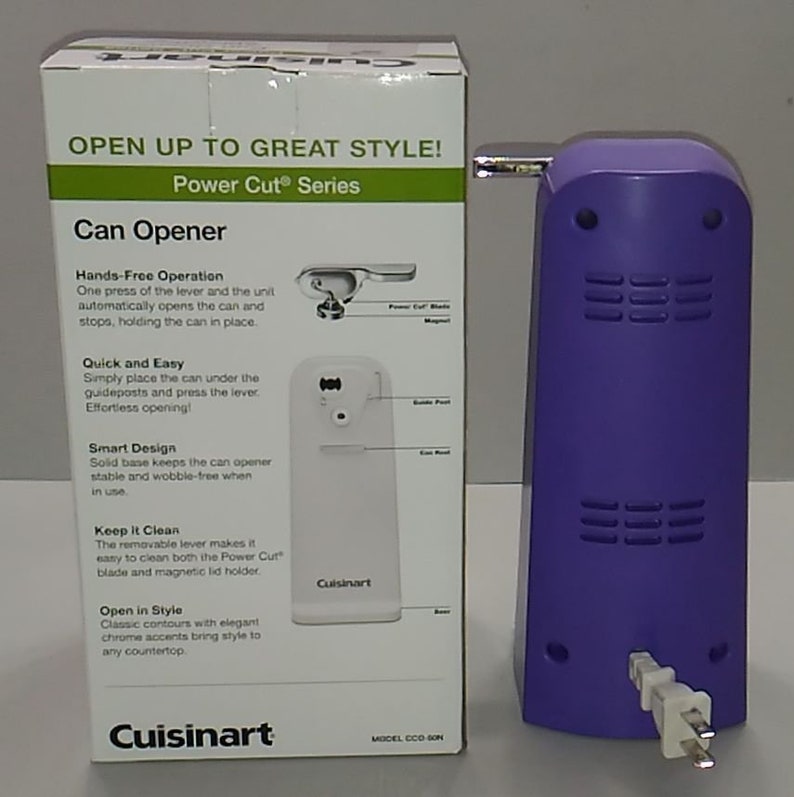 Puede incluir: Una caja blanca con un abrelatas el&eacute;ctrico morado. La caja tiene el texto "OPEN UP TO GREAT STYLE! Power Cut&reg; Series Can Opener" y detalles sobre las caracter&iacute;sticas del producto. El abrelatas tiene un cable y una palanca.