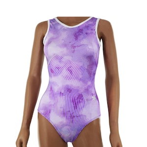 May include: A purple and white leotard with a geometric pattern. The sleeveless leotard has a white trim around the neckline and armholes. The fabric features a tie-dye effect with vertical stripes.