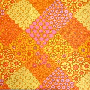 May include: A colourful, retro floral pattern in yellow, orange, and pink. The design features various sizes and styles of flowers arranged in diagonal stripes and scattered clusters, creating a lively and colourful textile design.