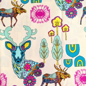 May include: A colorful fabric with a repeating pattern of stylized deer, moose, trees, and flowers. The background is a light cream color. The deer and moose are blue and green with yellow accents. The trees are green and yellow. The flowers are pink, yellow, and orange.