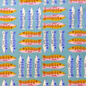 May include: A repeating pattern of stylized fish in shades of blue, yellow, pink, and red on a light blue background. The fish are arranged in rows and columns, creating a playful and whimsical design. The fish have detailed fins and scales.