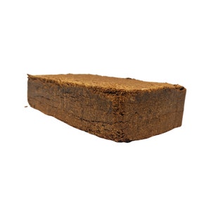 May include: A brown rectangular block of compressed coconut coir, a natural growing medium for plants.