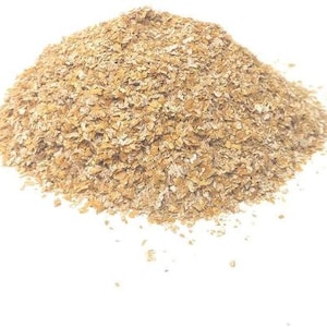 May include: A close-up of a pile of light brown wheat bran flakes.