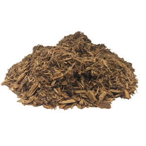 May include: A pile of brown wood chips, likely for gardening or mulching.