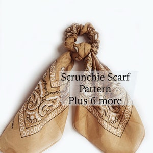 May include: A brown bandana with a white paisley pattern is tied into a scrunchie. The scrunchie is tied with a knot and the ends of the bandana are hanging down. The text "Scrunchie Scarf Pattern Plus 6 more" is written in black text on a white background.