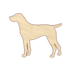 May include: A wooden cutout of a dog in a standing position. The dog is light brown and has a long snout and a long tail.