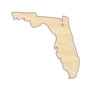 May include: A wooden cutout of the state of Florida. The cutout is light brown and has a smooth, unfinished surface.
