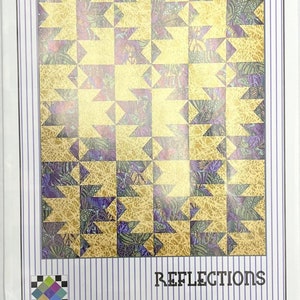 May include: A quilt pattern titled "Reflections" by Karen Montgomery. The design features a repeating pattern of gold and purple shapes. The package has a white background with vertical purple stripes and the "Designs by" logo.