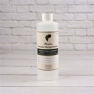 May include: A clear plastic bottle of Easy Press Fabric Treatment by Acorn Precision Piecing Products. The bottle is labeled with the product name, instructions, and the words "Non-Toxic, Non-Texture, No-Taste".