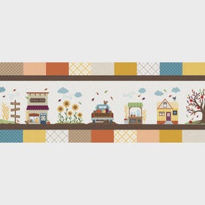 Puede incluir: Panel de tela con una escena otoñal. El diseño incluye una tienda general, girasoles, un camión que transporta calabazas, un puesto de sidra, una casa y un árbol. El panel tiene un borde de patchwork.