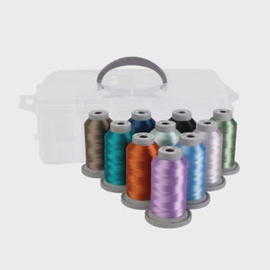 May include: A clear plastic storage container with a gray handle holds spools of colorful thread. The thread colors include brown, teal, orange, purple, blue, and green. The spools are arranged in a semi-circle.