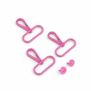 May include: Three pink metal swivel clasps and two pink metal snap fasteners.