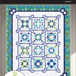 May include: Daydream quilt pattern by Swirly Girls featuring Tonga Dreamer by Timeless Treasures Fabrics. The quilt pattern features a white background with a grid of 12 colorful patchwork squares.