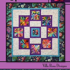 May include: A quilt pattern called "Hypnotized" by Villa Rosa Designs. The quilt features a colorful, abstract design with a central square surrounded by eight smaller squares. The quilt is made with a variety of fabrics in shades of blue, green, purple, and pink.