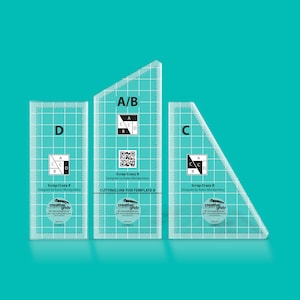 May include: Three clear plastic quilting rulers with grid lines and labeled sections A/B, C, and D. The rulers are labeled "Scrap Crazy 8" and "Designed by Karen Montgomery".