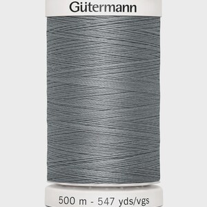 May include: A spool of Gütermann thread in a muted gray color. The spool has a white top and bottom with the brand name and thread length printed on it. The thread is 547 yards in length.