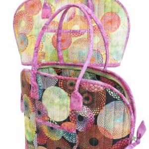 May include: Two quilted handbags with pink handles and a colorful geometric pattern. The smaller bag is stacked on top of the larger bag.