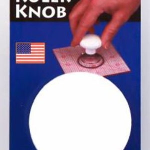 May include: White plastic ruler knob with the words "Ruler Knob" and "Get a Grip!" printed on a blue and white package. The package also includes the words "Cottage Mills" and "8003".