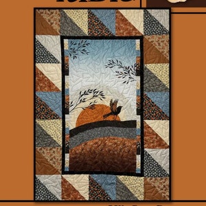 May include: A quilt with a central landscape scene featuring a sunset, bird, and branches, framed by patchwork triangles in various patterns and colors. The word "Fable" is at the top, and "Villa Rosa Designs" is at the bottom.